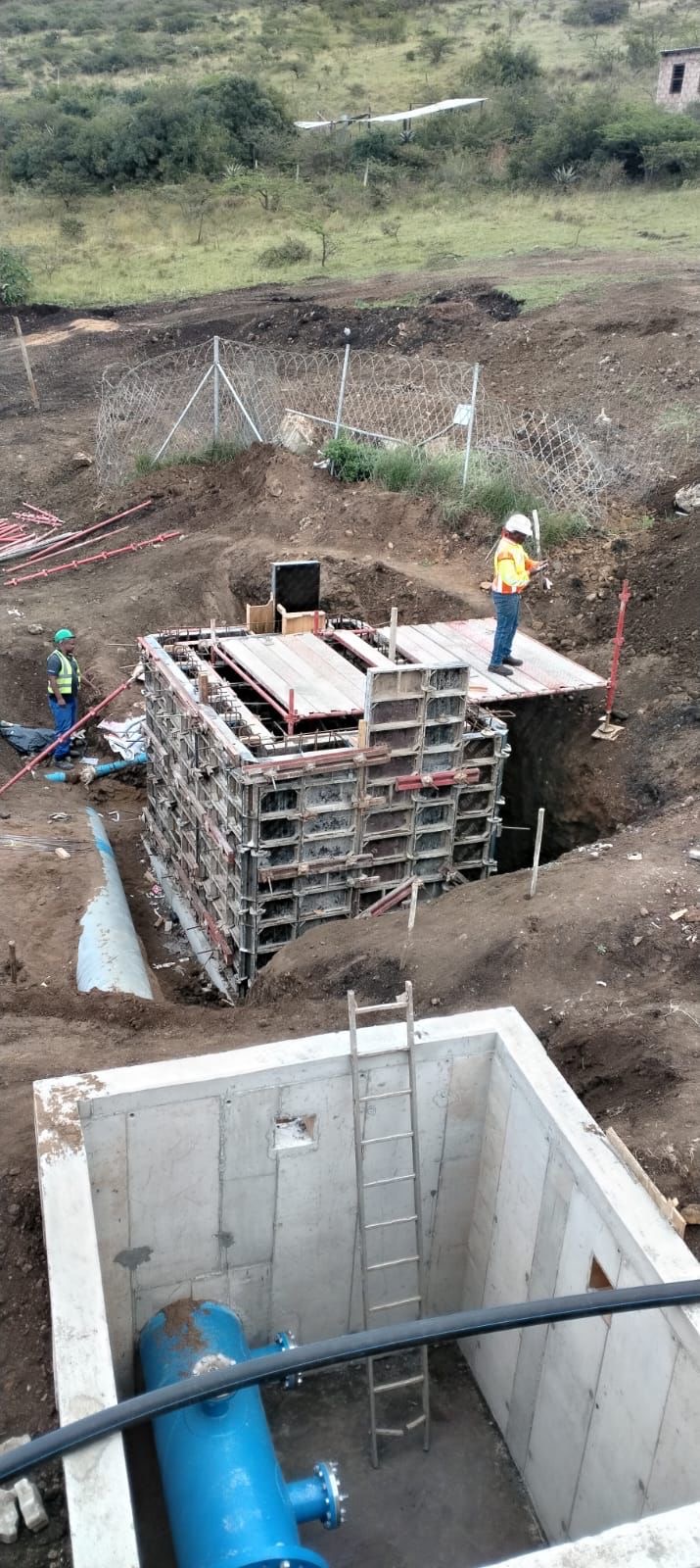 Water infrastructure formwork with concrete chamber and blue pipes