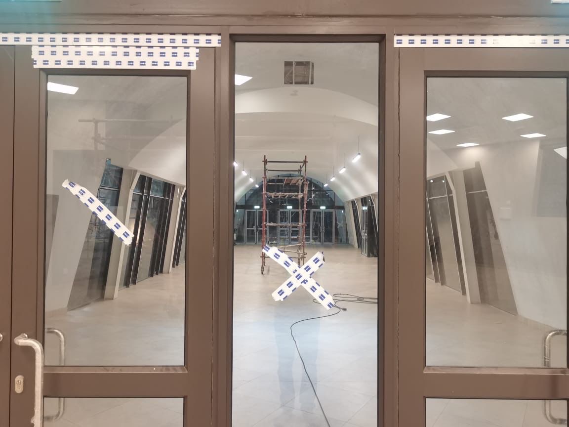 Glass doors with arched interior and scaffolding