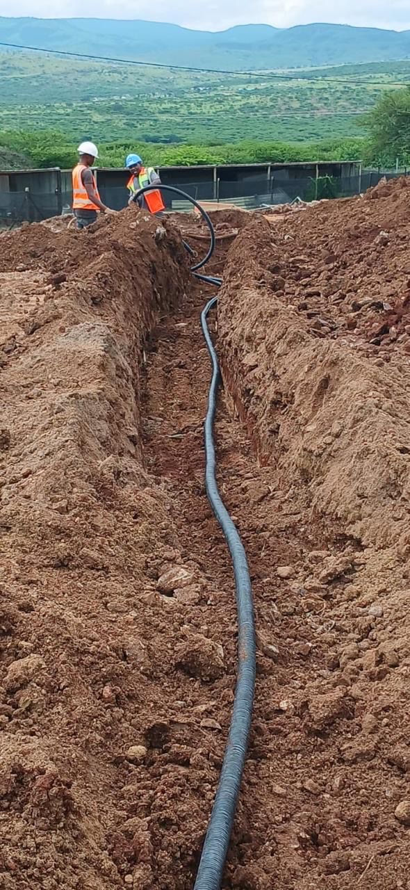 Trench with large pipe being laid in KZN landscape