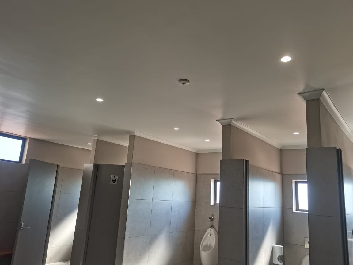 Commercial bathroom with urinals and downlights