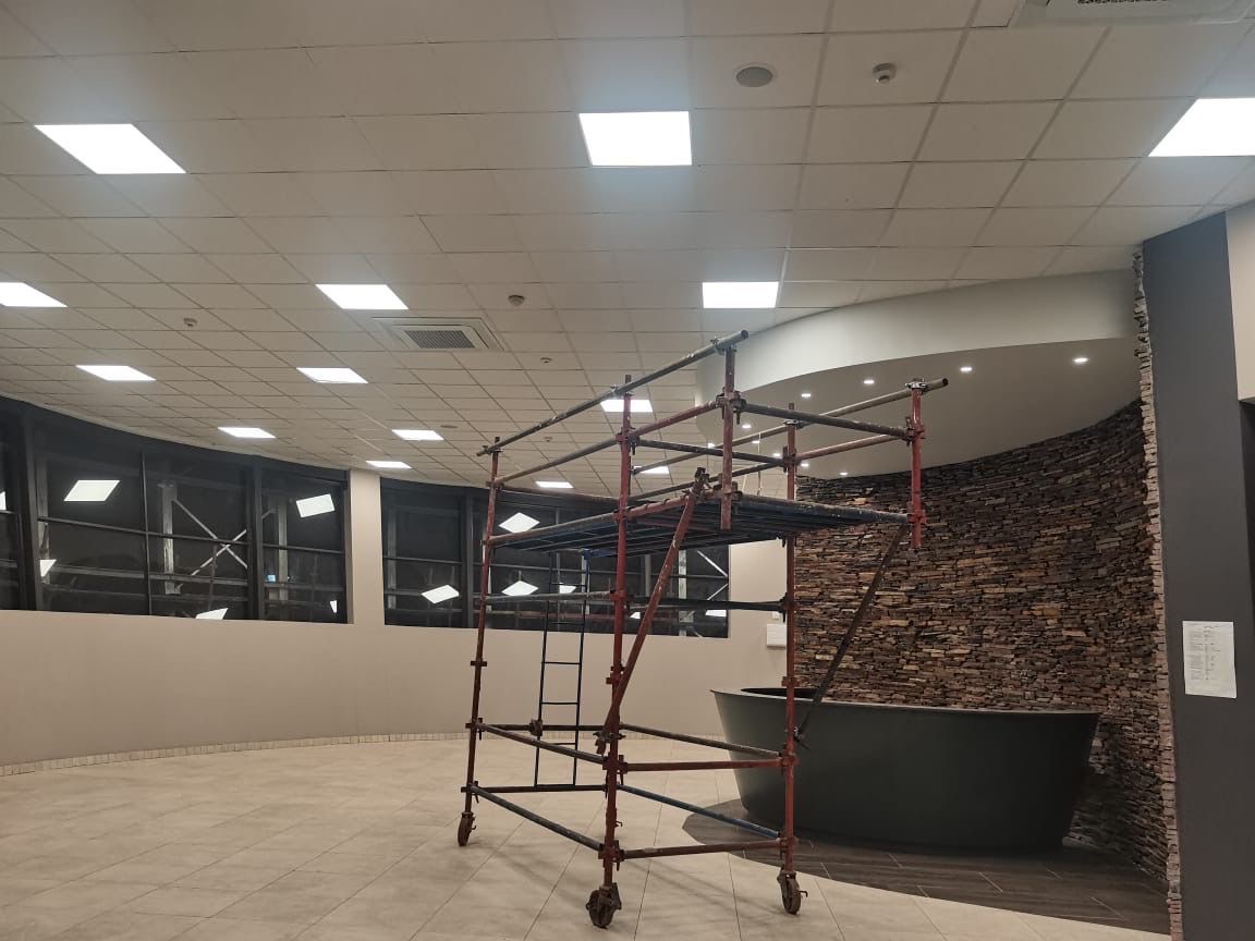Interior fitout with scaffolding and stone wall