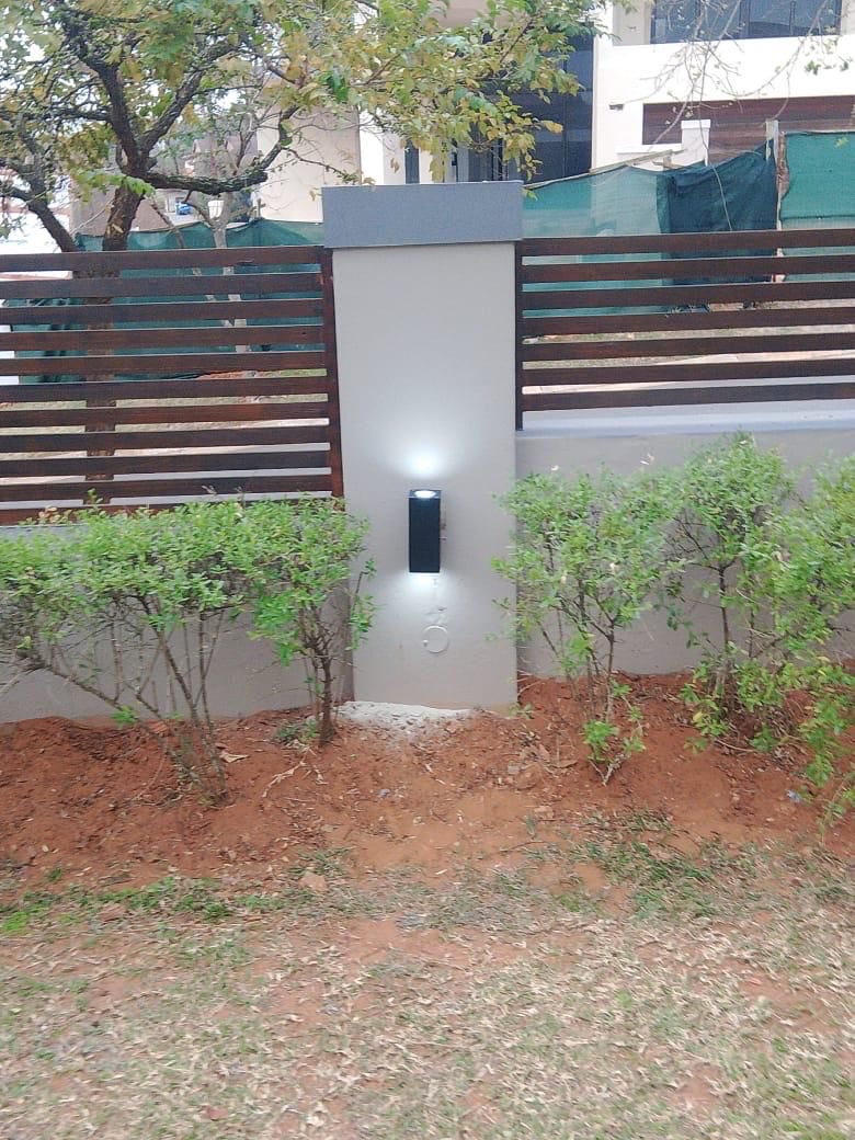 Wall light fixture on garden pillar