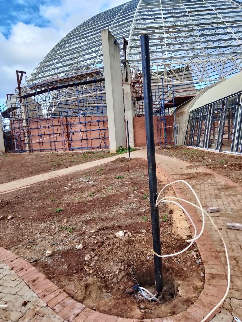 Light pole base with wiring near dome structure