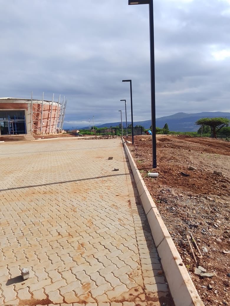 Light poles along paved area at construction site